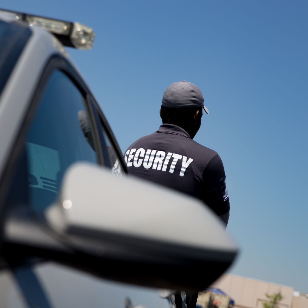 Security guard near a patrol car