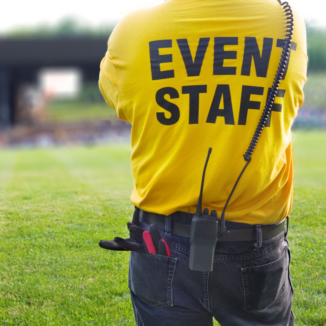 a man in a yellow shirt that says event staff